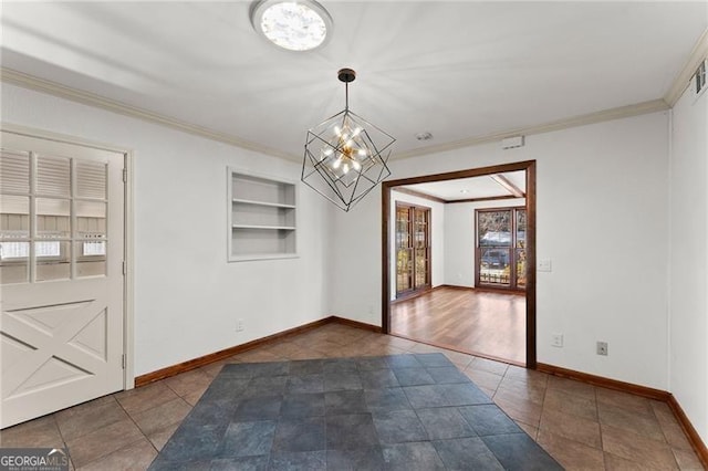 unfurnished dining area featuring built in features, a notable chandelier, ornamental molding, baseboards, and tile patterned floors