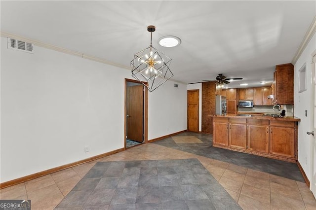 kitchen with visible vents, baseboards, brown cabinets, a peninsula, and stainless steel appliances