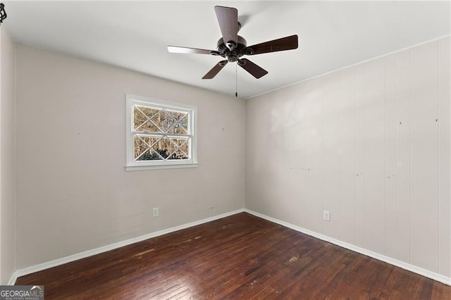 spare room with ceiling fan, baseboards, and wood finished floors