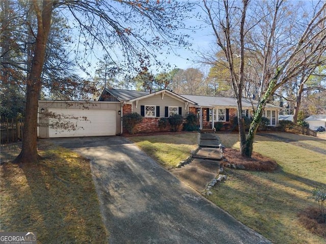 ranch-style house featuring aphalt driveway, brick siding, fence, a garage, and a front lawn