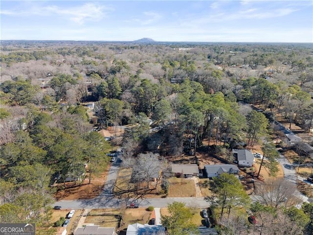 bird's eye view featuring a wooded view