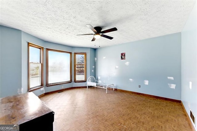 1505 Ozora Rd, Loganville, GA 30052 - unfurnished room featuring visible vents, ceiling fan, a textured ceiling, and baseboards