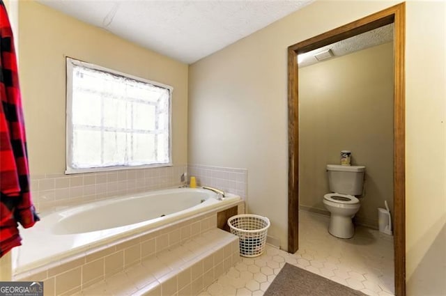 1505 Ozora Rd, Loganville, GA 30052 - bathroom featuring tile patterned flooring, a garden tub, and toilet