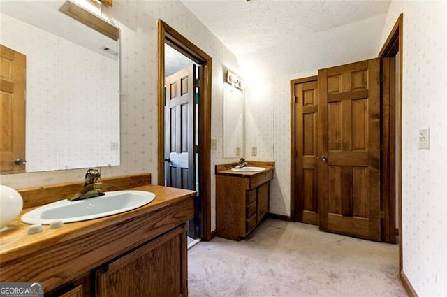 1505 Ozora Rd, Loganville, GA 30052 - bathroom featuring two vanities, a sink, baseboards, and wallpapered walls