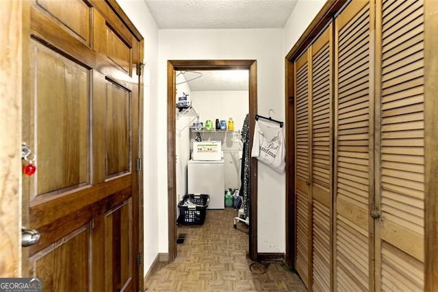 1505 Ozora Rd, Loganville, GA 30052 - corridor featuring a textured ceiling, washer / dryer, and baseboards