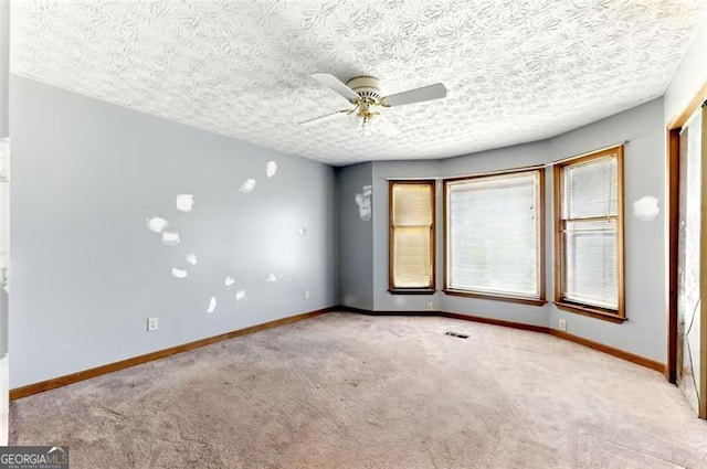 1505 Ozora Rd, Loganville, GA 30052 - empty room with ceiling fan, a textured ceiling, carpet, and baseboards