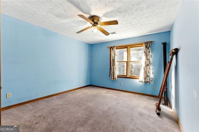 1505 Ozora Rd, Loganville, GA 30052 - carpeted spare room with baseboards, a textured ceiling, visible vents, and a ceiling fan