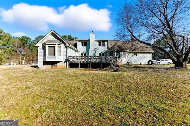 1505 Ozora Rd, Loganville, GA 30052 - rear view of house with a deck, a yard, and a chimney