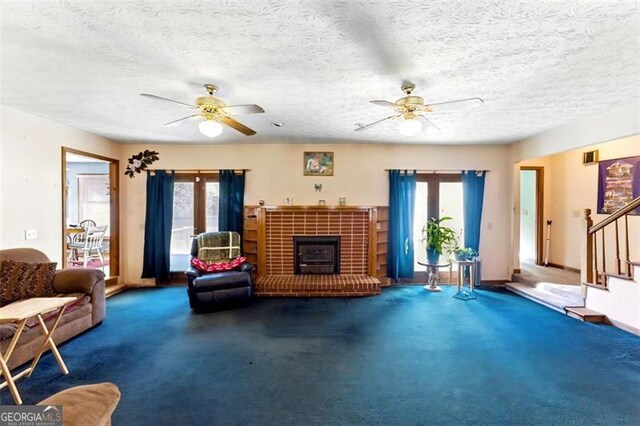 1505 Ozora Rd, Loganville, GA 30052 - carpeted living area featuring a ceiling fan, a textured ceiling, baseboards, and stairs