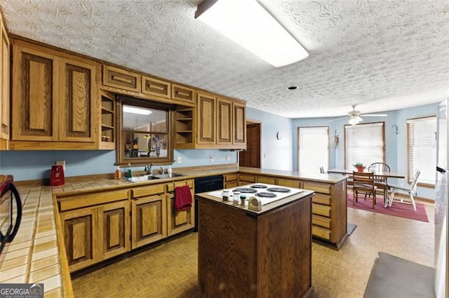 1505 Ozora Rd, Loganville, GA 30052 - kitchen featuring tile countertops, a center island, a peninsula, open shelves, and a sink