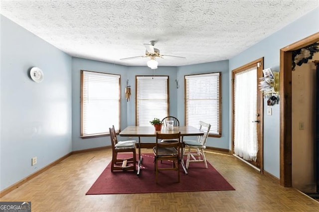 1505 Ozora Rd, Loganville, GA 30052 - dining space with ceiling fan, baseboards, and a textured ceiling