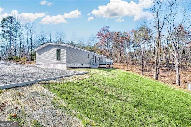 view of home's exterior featuring a yard and a wooden deck