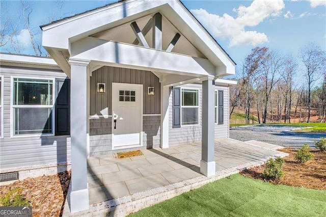 doorway to property with board and batten siding