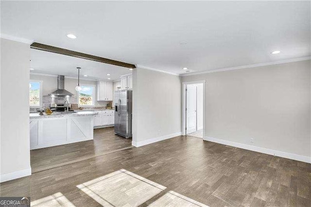 unfurnished living room featuring baseboards, dark wood finished floors, crown molding, and recessed lighting