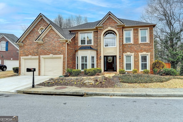 view of front of house featuring a garage, concrete driveway, brick siding, and roof with shingles