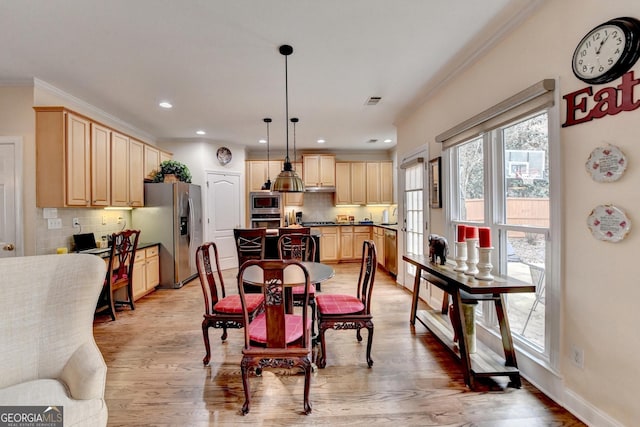 dining room with recessed lighting, visible vents, baseboards, ornamental molding, and light wood finished floors