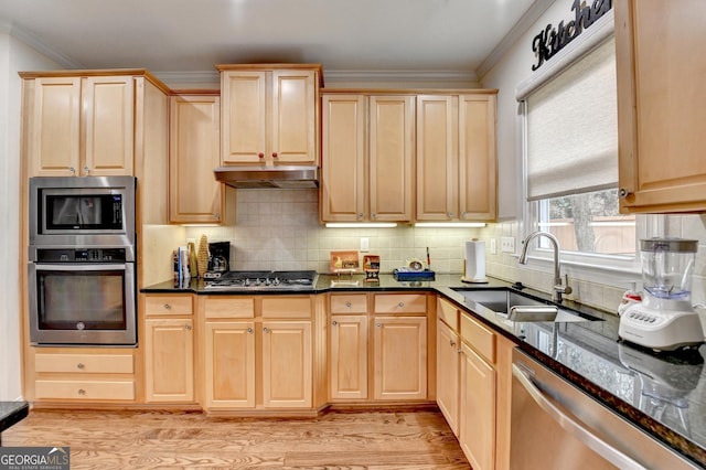 kitchen with stainless steel appliances, backsplash, light brown cabinets, a sink, and under cabinet range hood