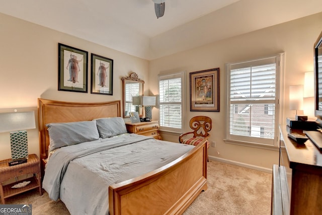 bedroom featuring ceiling fan, baseboards, and light colored carpet