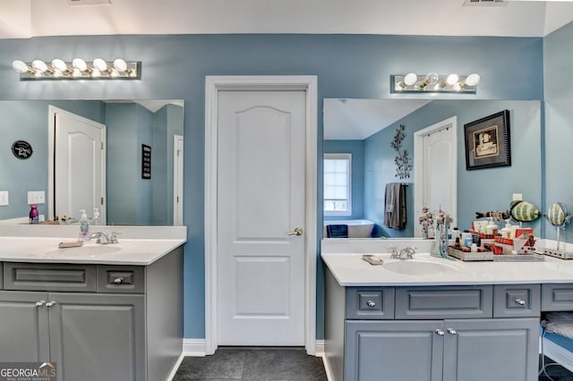 full bathroom with two vanities, a sink, visible vents, and tile patterned floors