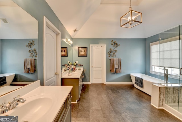 full bathroom featuring two vanities, a soaking tub, visible vents, and a sink