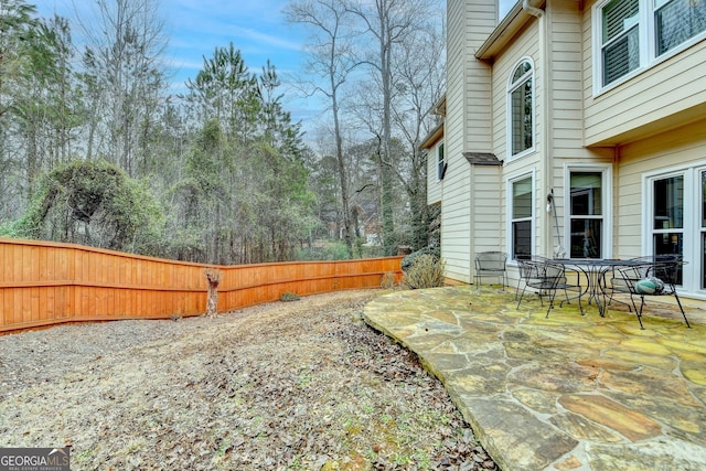 view of yard featuring fence and a patio