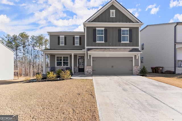 craftsman-style house with driveway, stone siding, an attached garage, a porch, and board and batten siding