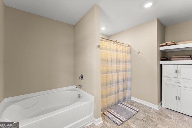 bathroom with a tub to relax in, a shower with curtain, baseboards, and recessed lighting