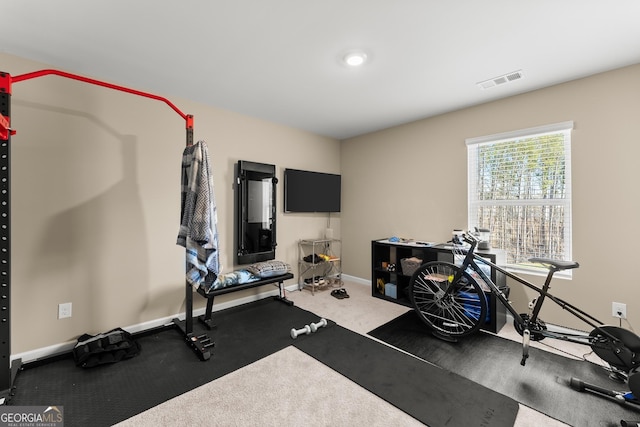 exercise room with visible vents and baseboards