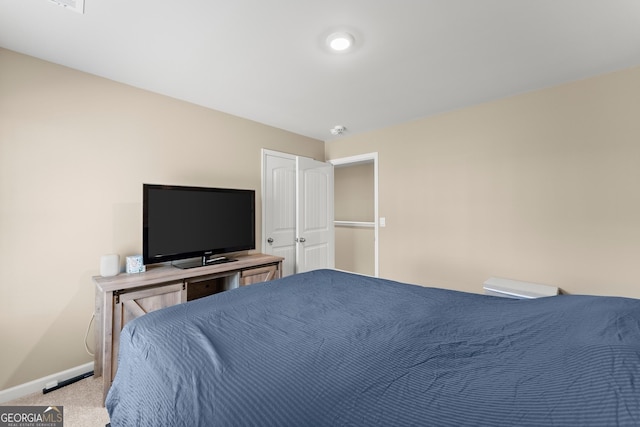 bedroom featuring carpet floors and baseboards