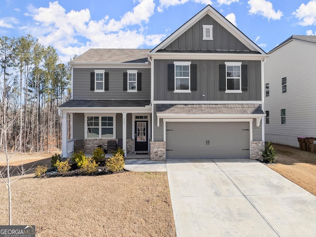 craftsman inspired home with brick siding, covered porch, concrete driveway, board and batten siding, and a garage