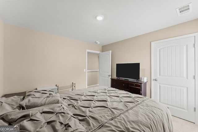 bedroom with light carpet and visible vents