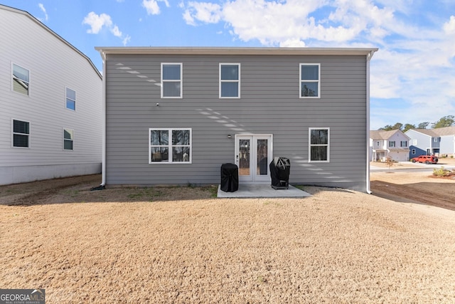 back of property with french doors and a patio area