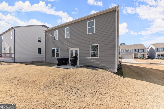 rear view of house with a yard and a patio