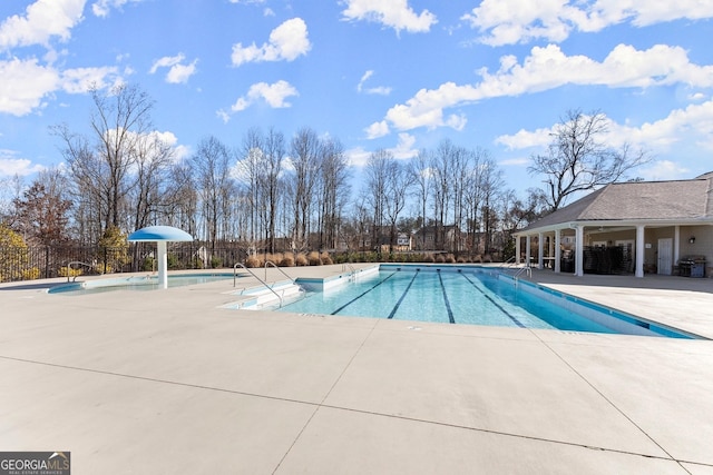 pool featuring a patio area and fence