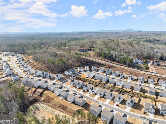 aerial view featuring a residential view and a view of trees