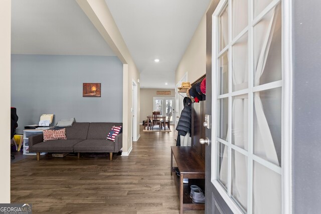 interior space with baseboards, wood finished floors, and recessed lighting