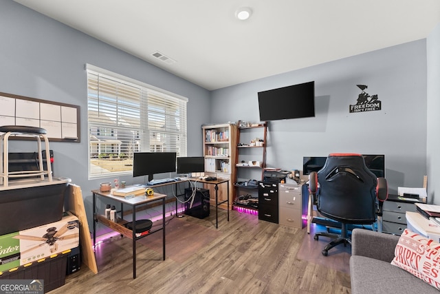 office area with visible vents and wood finished floors