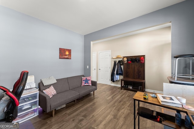 living area with baseboards and wood finished floors