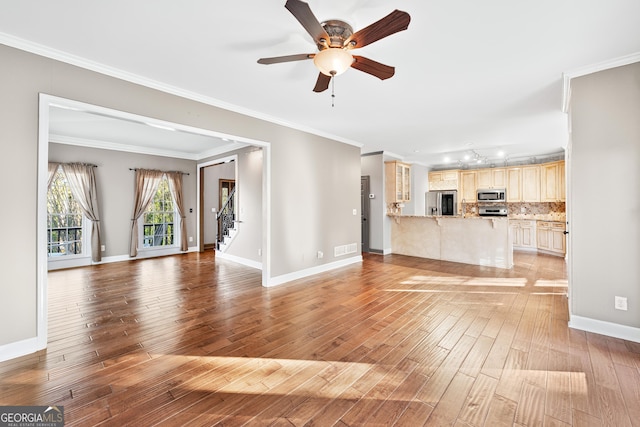 160 Deer Cliff Cv, Lawrenceville, GA 30043 - unfurnished living room with crown molding, stairway, light wood-style floors, and ceiling fan