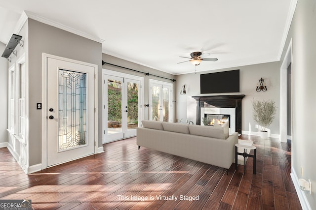 160 Deer Cliff Cv, Lawrenceville, GA 30043 - living room with baseboards, dark wood-style flooring, ceiling fan, ornamental molding, and a glass covered fireplace