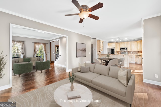 160 Deer Cliff Cv, Lawrenceville, GA 30043 - living area with stairway, ceiling fan, crown molding, and light wood-style floors