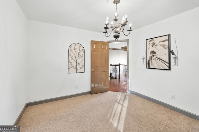 160 Deer Cliff Cv, Lawrenceville, GA 30043 - carpeted empty room featuring baseboards and an inviting chandelier