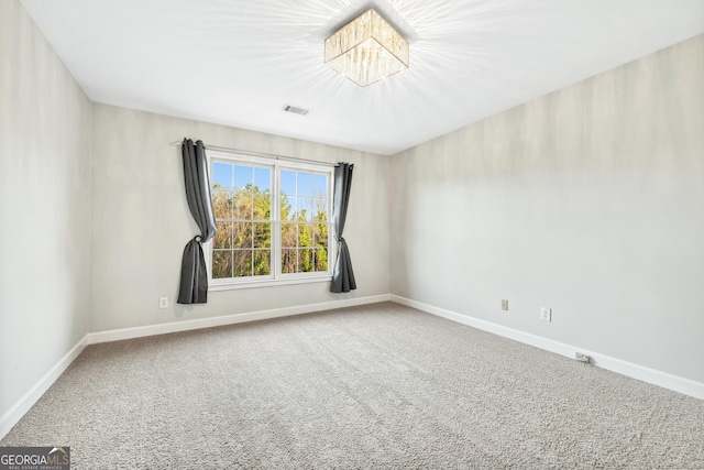 160 Deer Cliff Cv, Lawrenceville, GA 30043 - carpeted spare room featuring a notable chandelier, visible vents, and baseboards