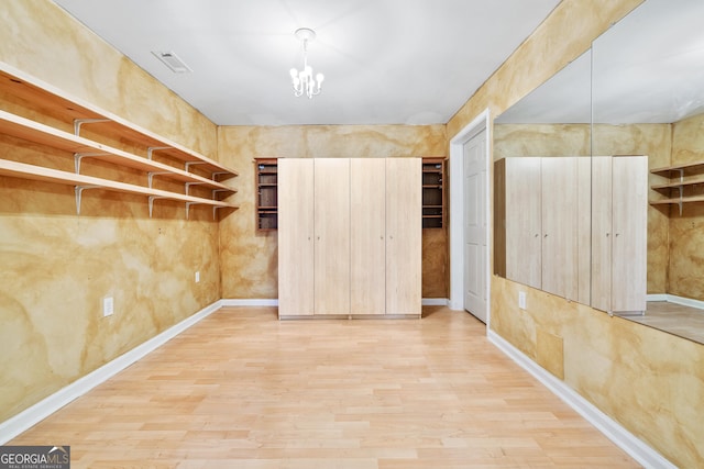160 Deer Cliff Cv, Lawrenceville, GA 30043 - interior space with a notable chandelier, wood finished floors, and visible vents
