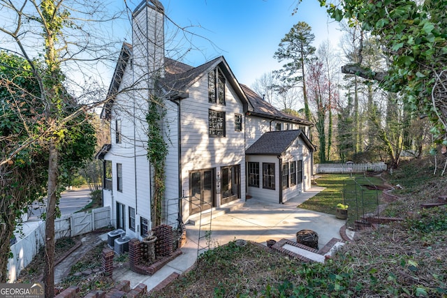 160 Deer Cliff Cv, Lawrenceville, GA 30043 - back of house with a patio area, a fire pit, a fenced backyard, and a chimney