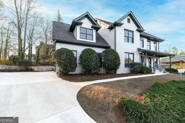 160 Deer Cliff Cv, Lawrenceville, GA 30043 - view of front of house with brick siding, a porch, a shingled roof, and fence