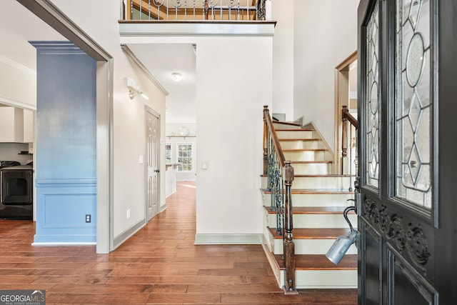 160 Deer Cliff Cv, Lawrenceville, GA 30043 - foyer entrance with stairway, crown molding, a towering ceiling, and wood finished floors
