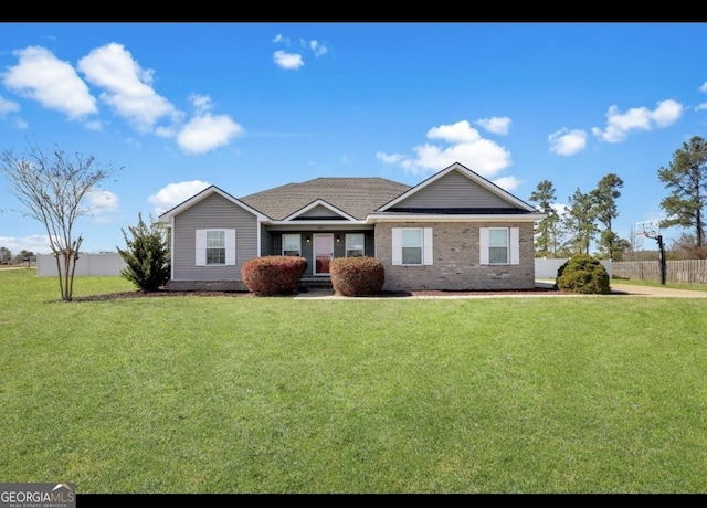 single story home with brick siding, fence, and a front yard