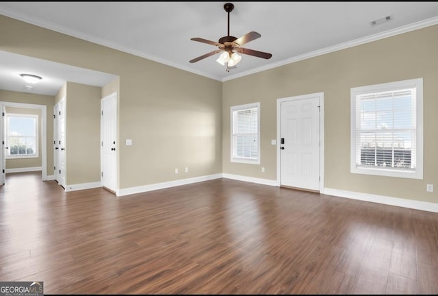 unfurnished living room with dark wood-style floors, visible vents, crown molding, and baseboards