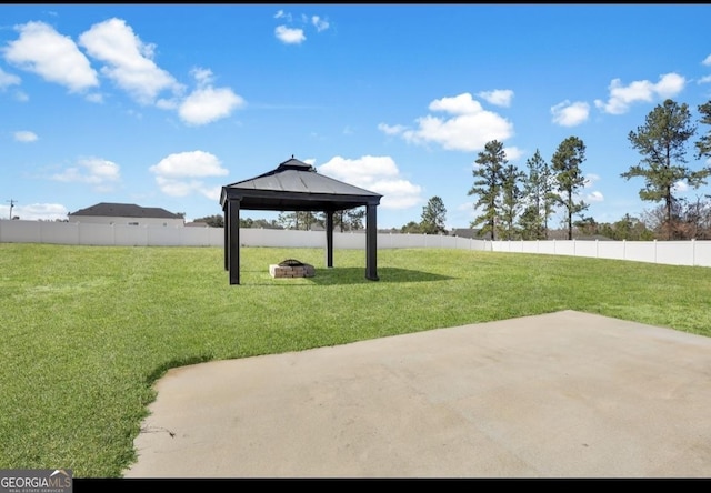 view of home's community featuring a yard, a gazebo, an outdoor fire pit, a patio area, and a fenced backyard